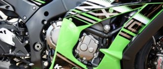 Four-stroke engine on the frame of a Kawasaki Ninja ZX-10R motorcycle, hidden behind green fairings